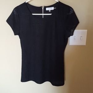 Really cute black blouse with lace.